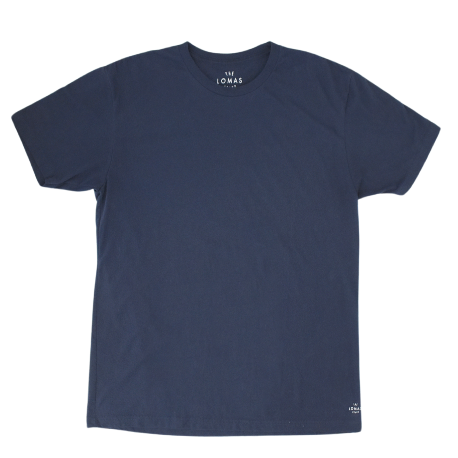 Photo of a flat navy soft t-shirt with a white "THE LOMAS BRAND" written in a stylized circle on the lower left of the shirt. The shirt is blank otherwise.