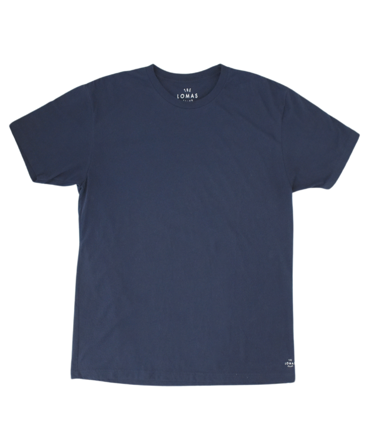Photo of a flat navy soft t-shirt with a white "THE LOMAS BRAND" written in a stylized circle on the lower left of the shirt. The shirt is blank otherwise.