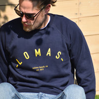 Man who is wearing Navy Crewneck Sweatshirt with yellow/gold lettering that says "Lomas, Solana Beach, CA, EST 2015" - The Lomas Brand