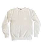 Cream beige colored crewneck sweatshirt laid flat. It has long sleeves and a small logo printed on the chest that says "THE LOMAS BRAND" with a small icon in white. The icon shows a saguaro cactus, a sun, and a bird. 