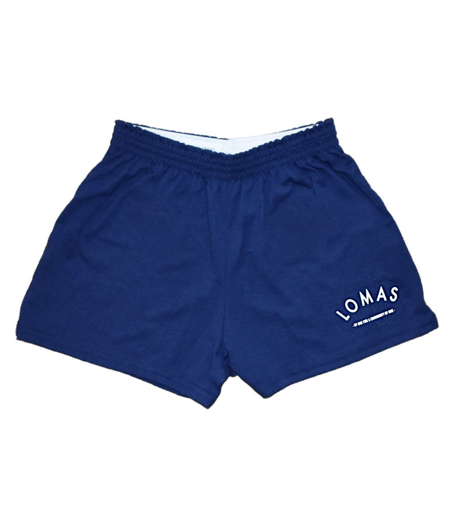 Short and cheeky blue shirts featuring an arched 'Lomas' written on the lower left of the front leg in white. Below the arch 'By One for a Community of One' in smaller font, also in white. 