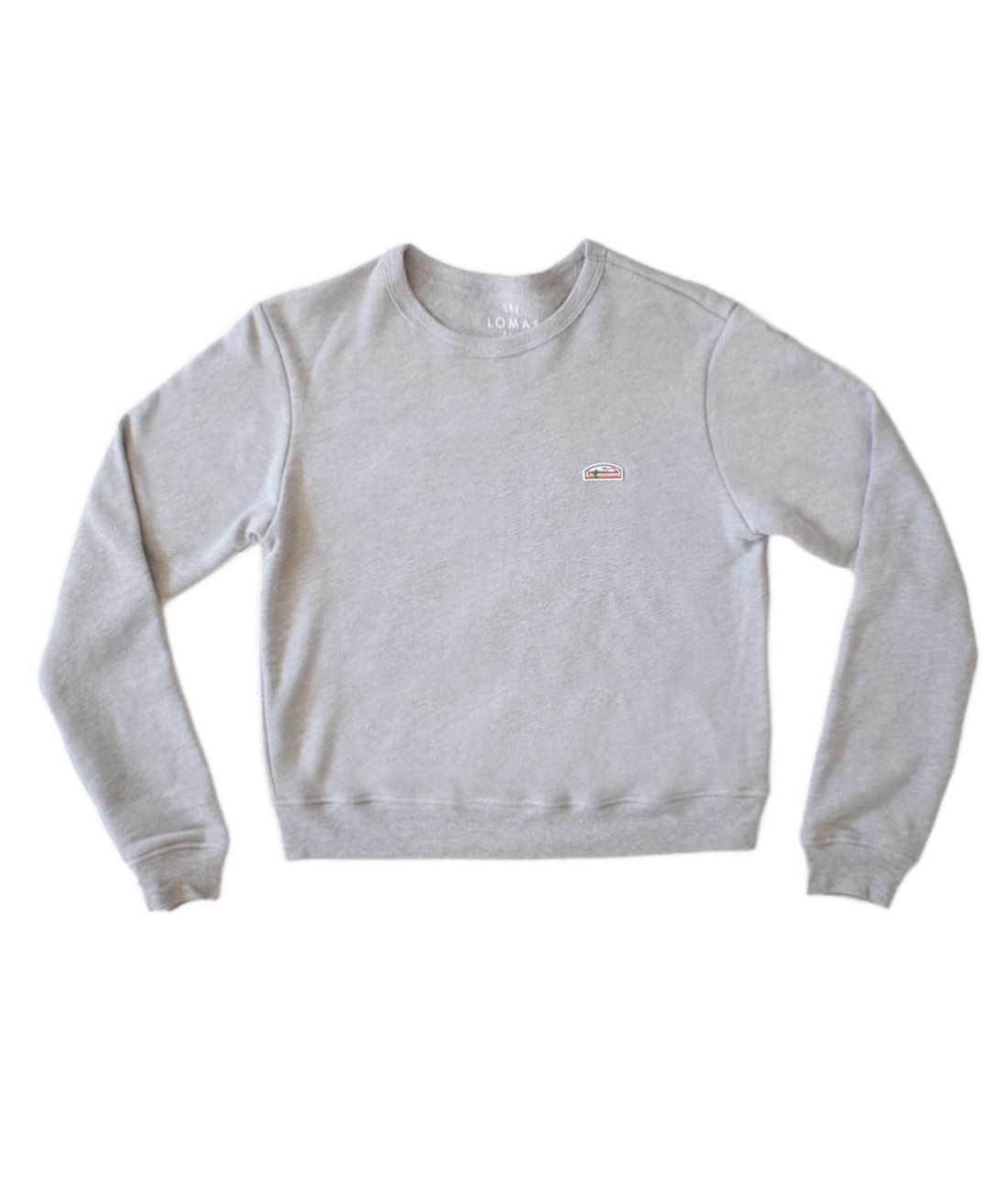 Thick yet breathable and feather soft grey crewneck sweatshirt with a shorter fit just above the waist. The upper left portion of the sweatshirt bears The Lomas Brand's iconic patch, executed in a striking tri-color scheme of white, orange, and green. The design features a saguaro with reaching limbs, an airborne bird, and an emerging sun.