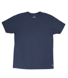 Photo of a flat navy soft t-shirt with a white "THE LOMAS BRAND" written in a stylized circle on the lower left of the shirt. The shirt is blank otherwise. 