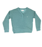 Flat photo of a soft teal cardigan v-neck sweater. There is a small "Lomas" icon on the upper left chest, in a white cursive script.