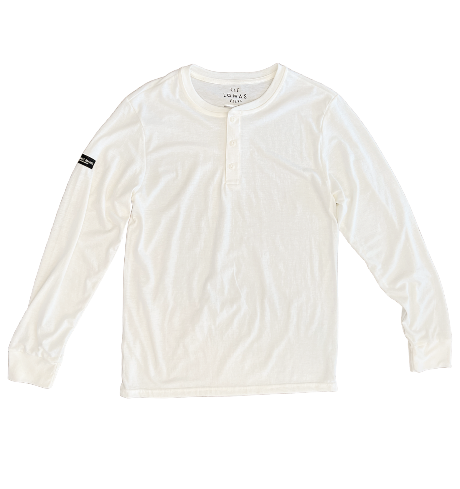 White long-sleeved shirt laid flat. It has a henley-style neckline with a few buttons. The Lomas Brand is shown as the tag, and a black patch is sewn on the right sleeve.