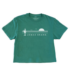 Green t-shirt with "THE LOMAS BRAND" printed in white, featuring stylized cactus and sun graphics. Short-sleeved crew neck style in a vibrant kelly green color.