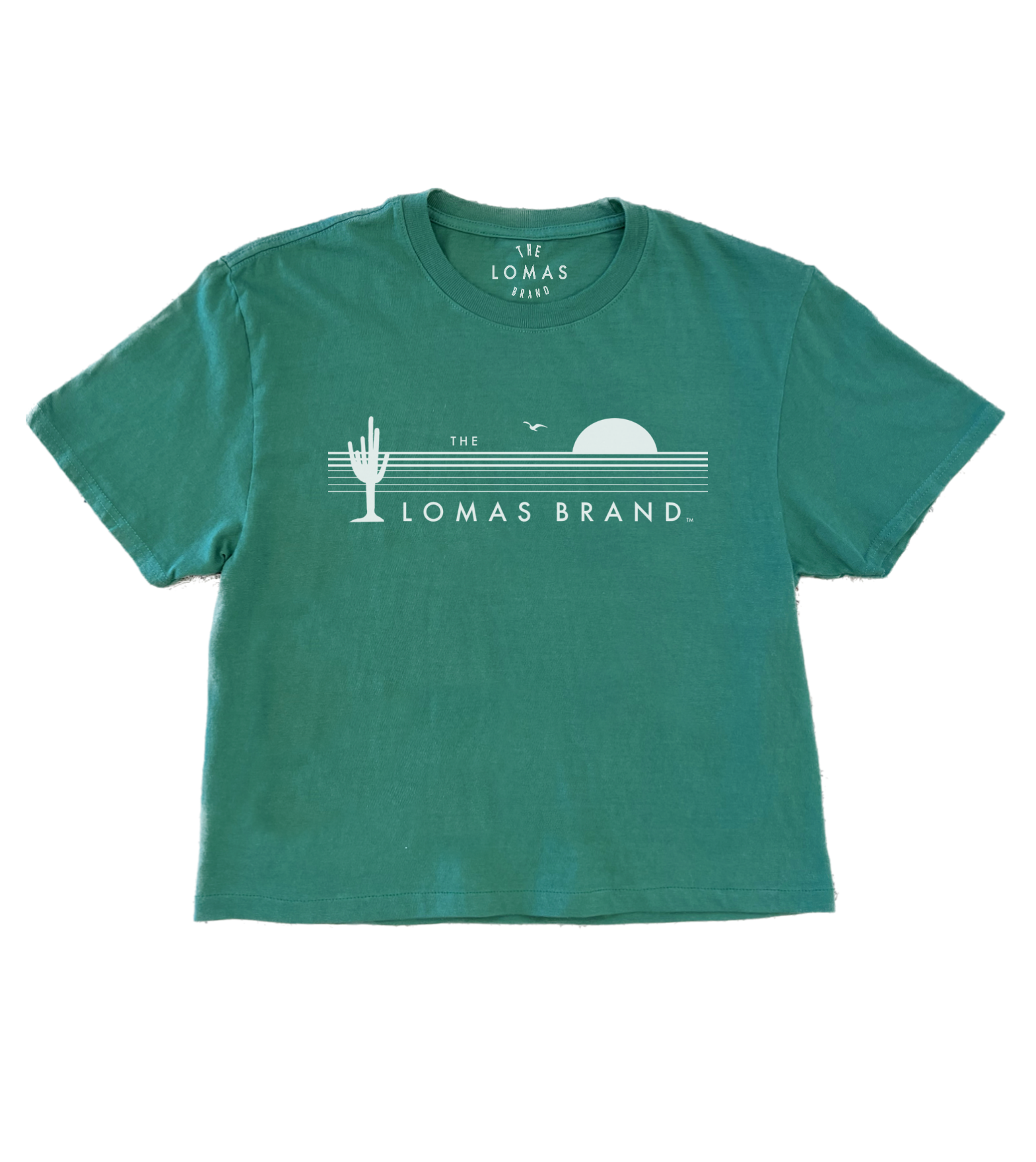 Green t-shirt with "THE LOMAS BRAND" printed in white, featuring stylized cactus and sun graphics. Short-sleeved crew neck style in a vibrant kelly green color.