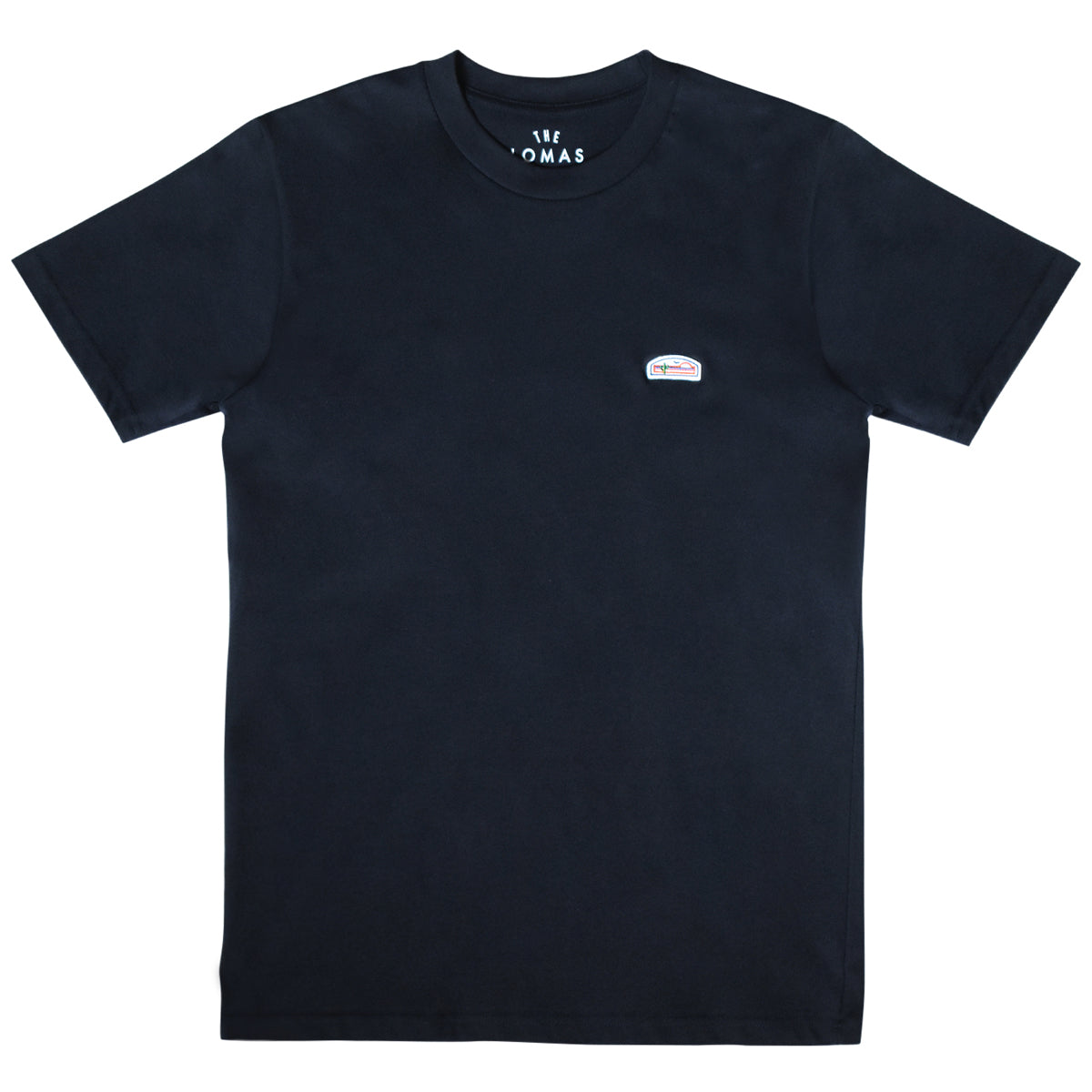 Flat photo of a high-quality deep navy blue short sleeve crewneck shirt. The shirt has a patch on the upper left side, featuring The Lomas Brand sunrise logo with elements of green, orange, and white. The patch has a cactus, a bird, and a rising sun. 