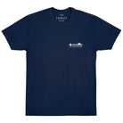 Flat photo of a soft navy blue shirt with a white logo on the upper left chest. The logo says "THE LOMAS BRAND" with a saguaro cactus, a flying bird, and a rising sun. 